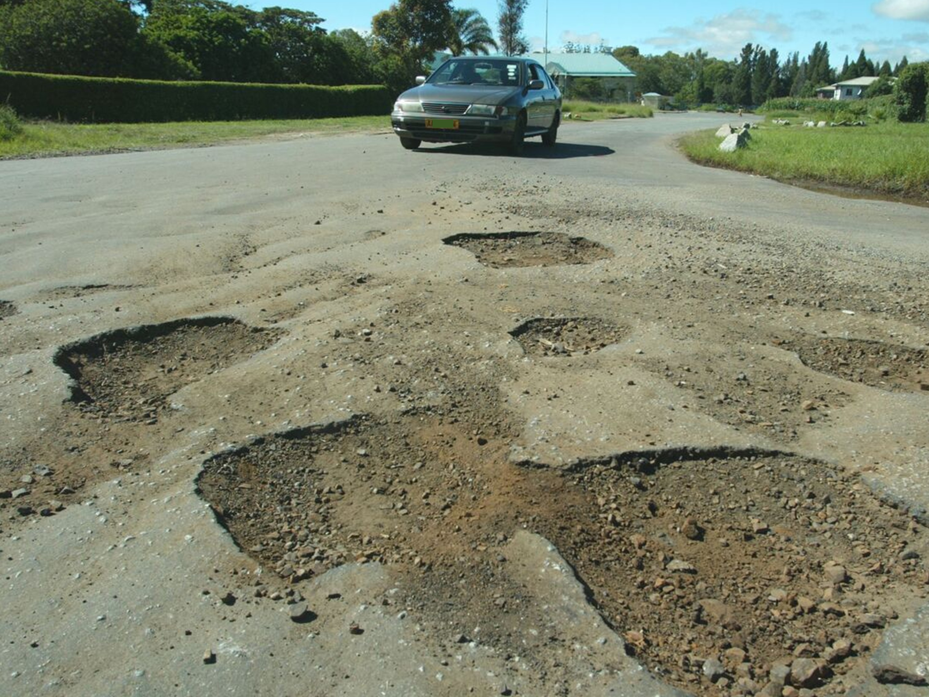 A vehicle on dilapidated road